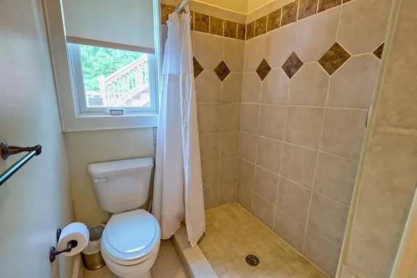 a bathroom with a shower sink and mirror