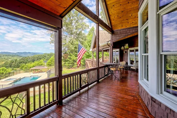 a kitchen with stainless steel appliances granite countertop a stove and a view of living room