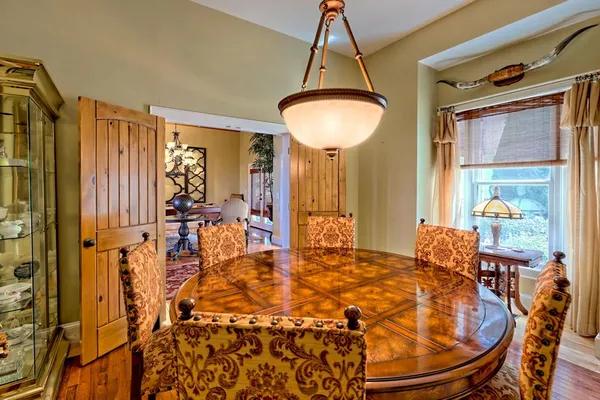 a living room with furniture a fireplace and a chandelier