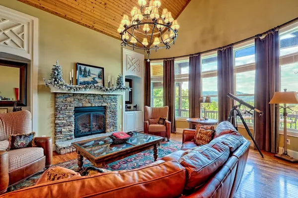 a living room with furniture a fireplace and a large window