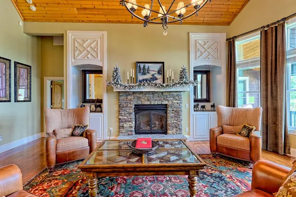 a living room with furniture and a chandelier