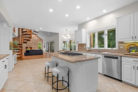 a kitchen with stainless steel appliances granite countertop a stove and a sink