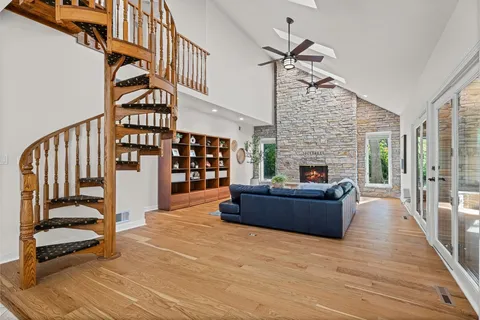 a living room with furniture fireplace and stairs