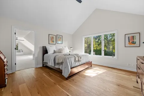 a bedroom with a bed and a large window