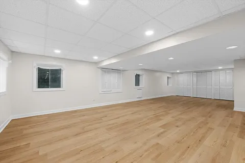 an empty room with wooden floor and window