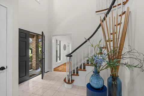 a view of entryway with wooden floor and stairs