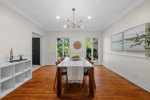 a view of a dining room with furniture window and wooden floor
