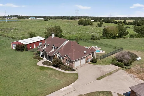 an aerial view of a house with outdoor space