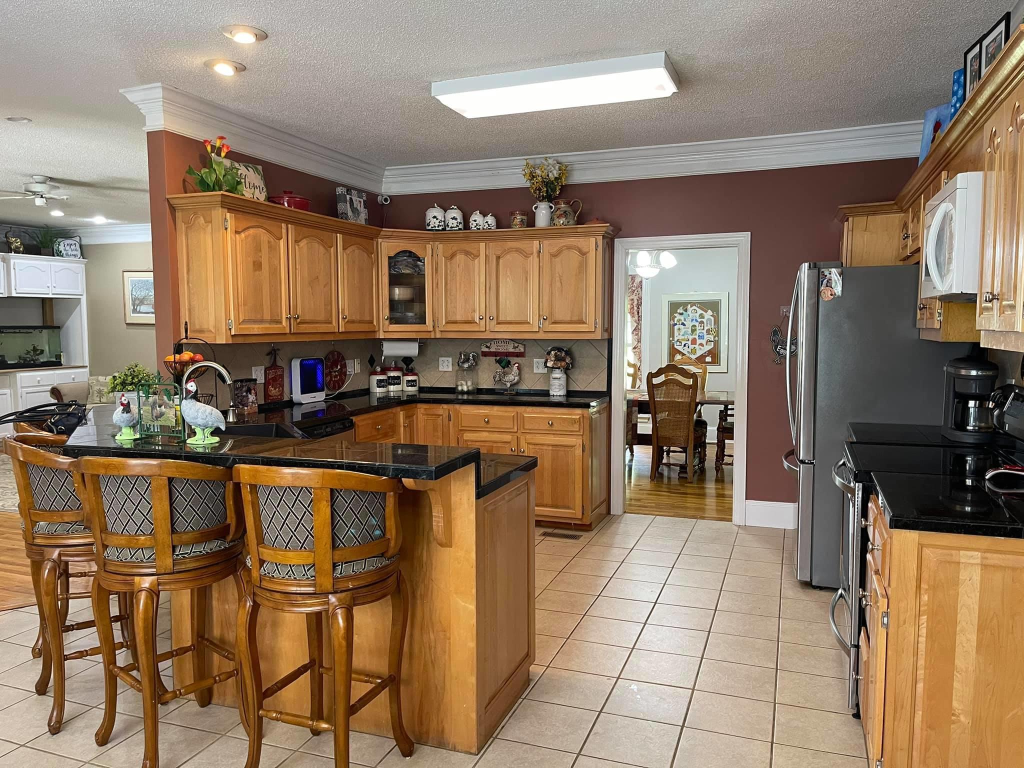 21127 Benvalen Road Andalusia, AL 36420 - Photo 2 of 36 a kitchen with stainless steel appliances granite countertop a stove a sink and a refrigerator