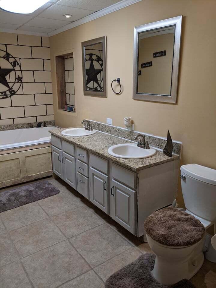 21127 Benvalen Road Andalusia, AL 36420 - Photo 27 of 36 a bathroom with a granite countertop sink and a toilet