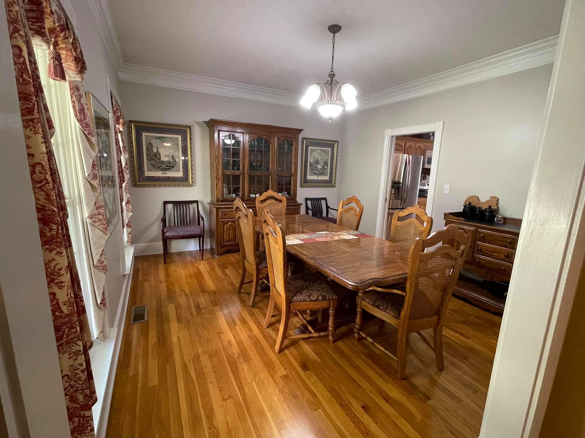 21127 Benvalen Road Andalusia, AL 36420 - Photo 4 of 36 a view of a dining room with furniture wooden floor and chandelier