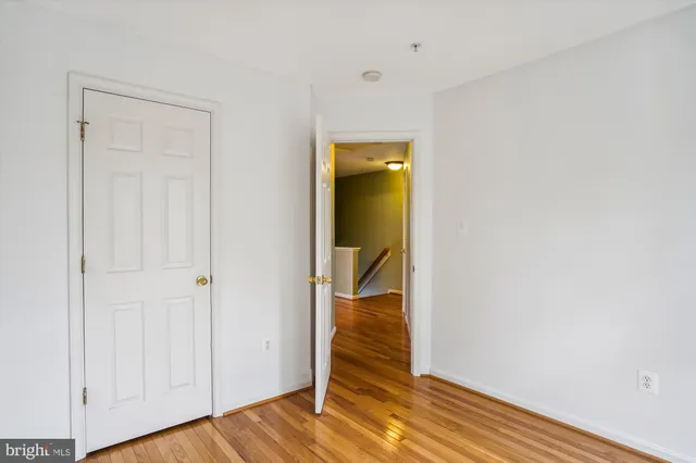 an empty room with wooden floor and closet