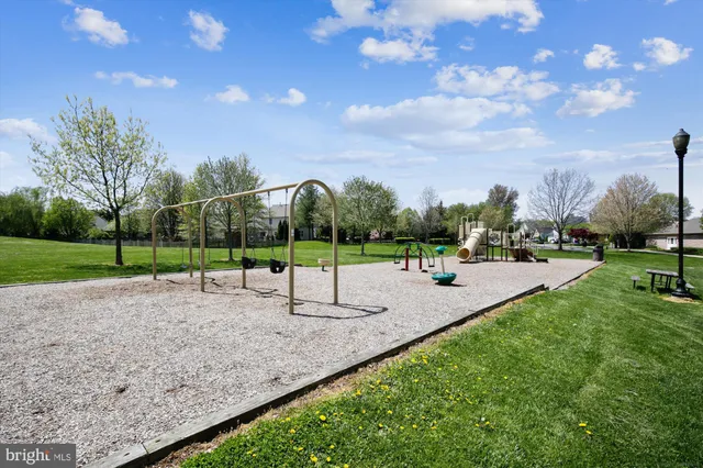 a city view with cars parked on the roadside