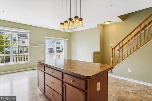 a kitchen with stainless steel appliances granite countertop a sink refrigerator and cabinets