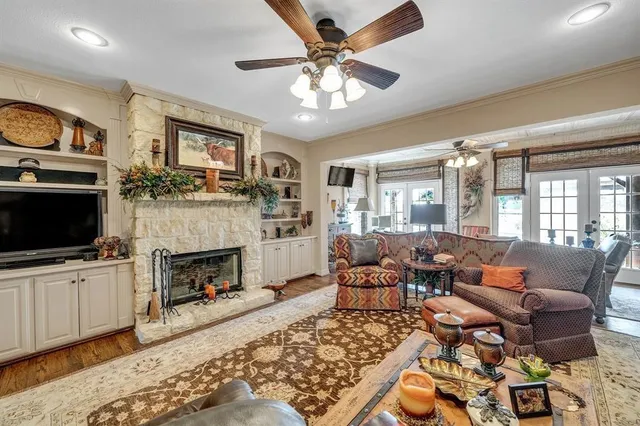 a living room with furniture a flat screen tv and a fireplace