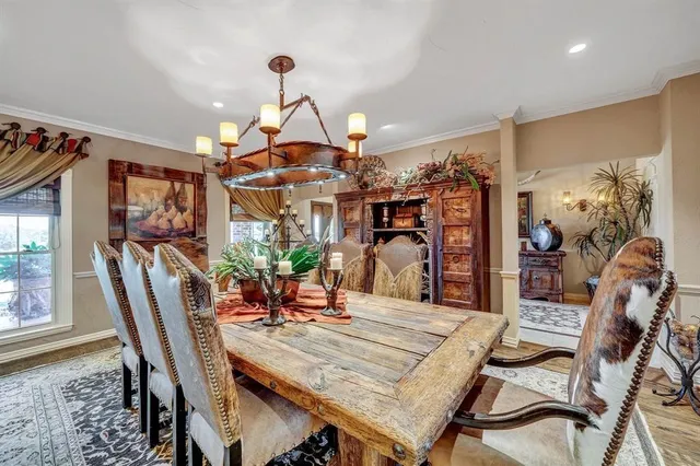 a view of a dining room with furniture a chandelier and wooden floor