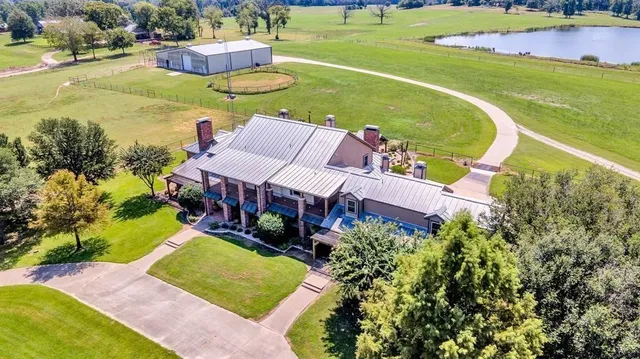an aerial view of a house with a garden and swimming pool