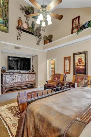 a bedroom with furniture and a flat screen tv