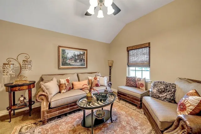 a living room with furniture a chandelier and a window