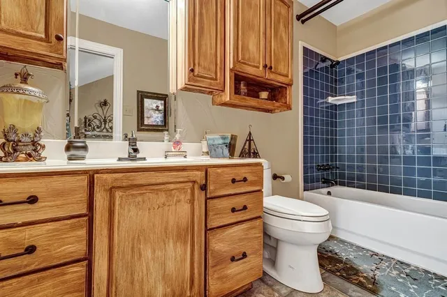 a bathroom with a sink toilet vanity and tub