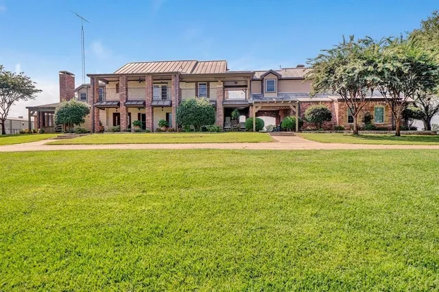 a front view of a building with a garden
