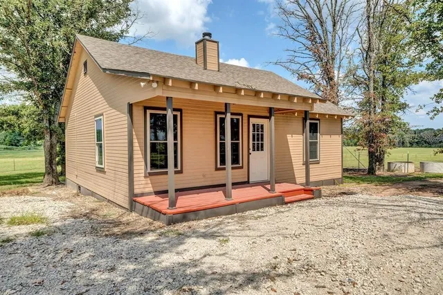 a backyard of a house with dishwasher and wooden fence