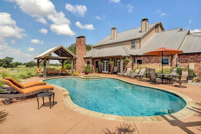 an outdoor space with swimming pool and furniture