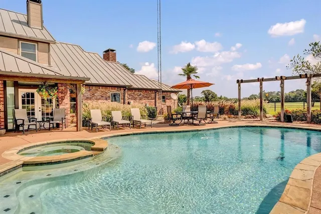 a view of a swimming pool with a patio