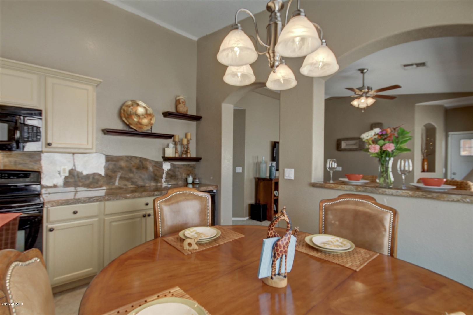 923 South Racine Lane Gilbert, AZ 85296 - Photo 12 of 32 a kitchen with a table chairs and a stove