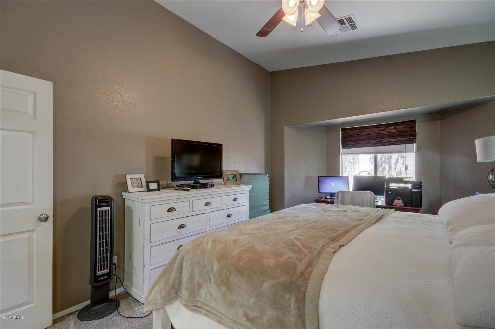 923 South Racine Lane Gilbert, AZ 85296 - Photo 16 of 32 a bedroom with a bed and a flat screen tv
