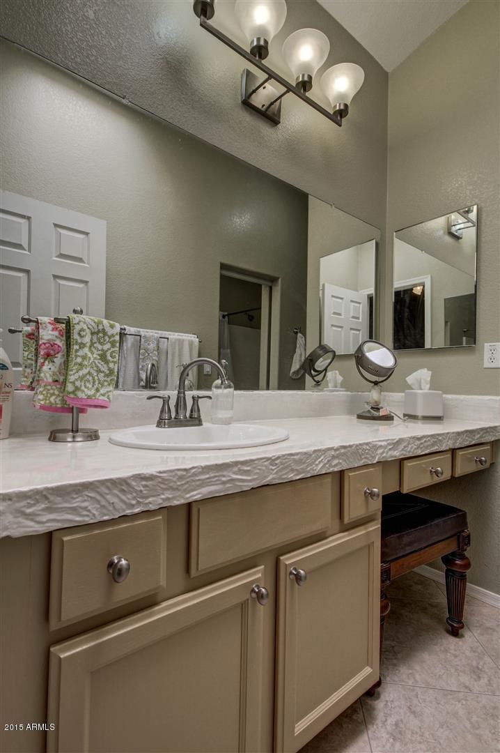 923 South Racine Lane Gilbert, AZ 85296 - Photo 18 of 32 a bathroom with a granite countertop sink a toilet and mirror