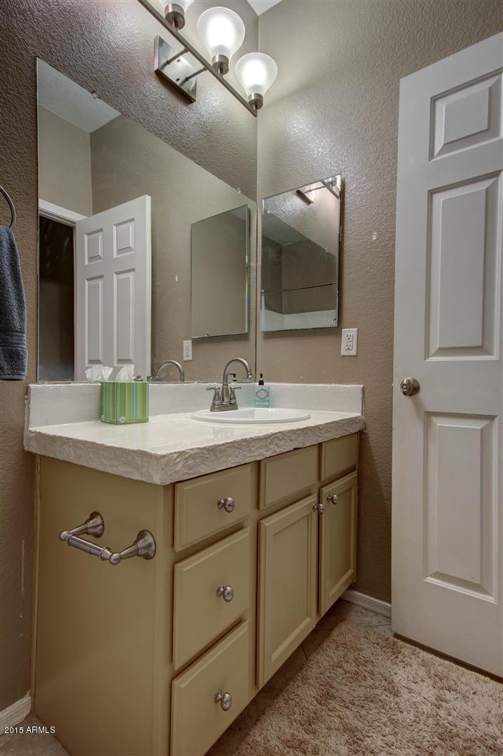 923 South Racine Lane Gilbert, AZ 85296 - Photo 22 of 32 a bathroom with a sink and a mirror