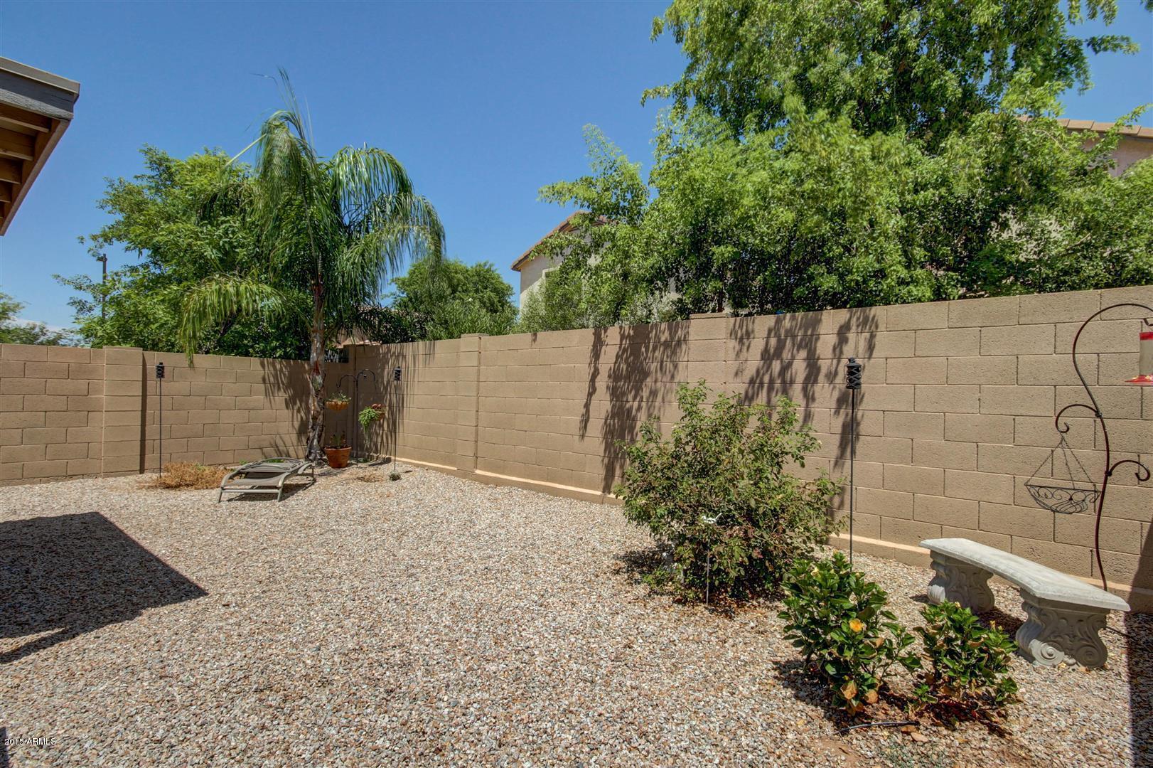 923 South Racine Lane Gilbert, AZ 85296 - Photo 24 of 32 a backyard of a house with lots of green space