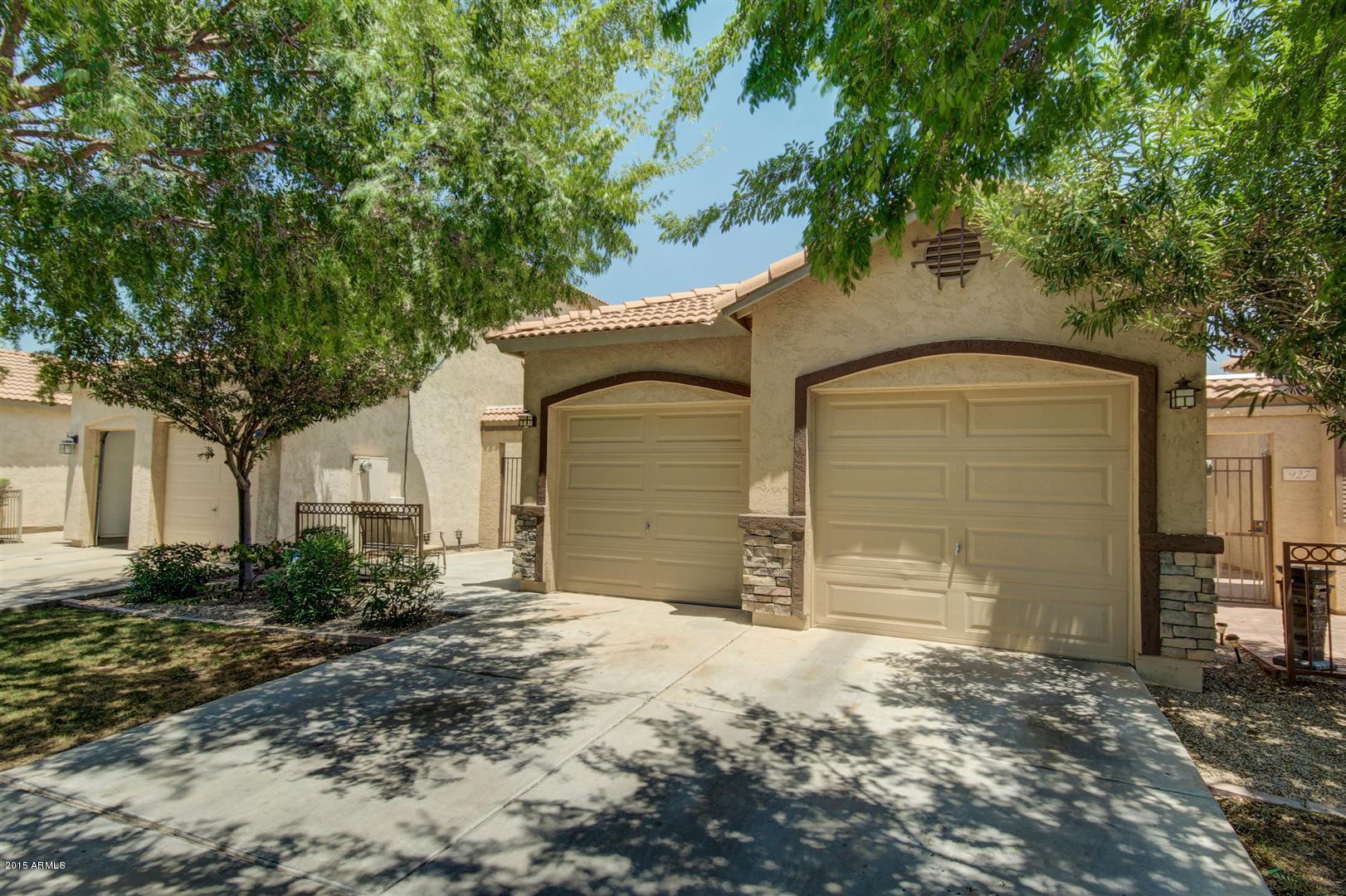 923 South Racine Lane Gilbert, AZ 85296 - Photo 3 of 32 a front view of a house with a yard