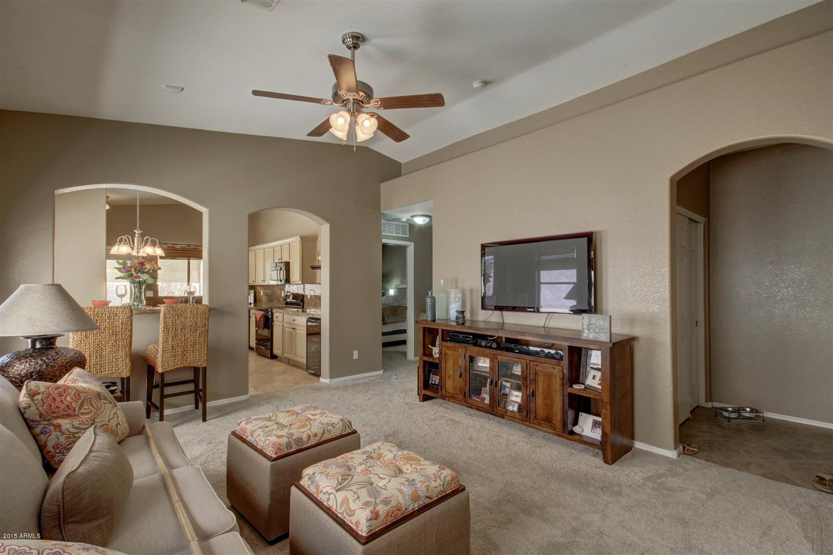 923 South Racine Lane Gilbert, AZ 85296 - Photo 4 of 32 a living room with furniture and a chandelier