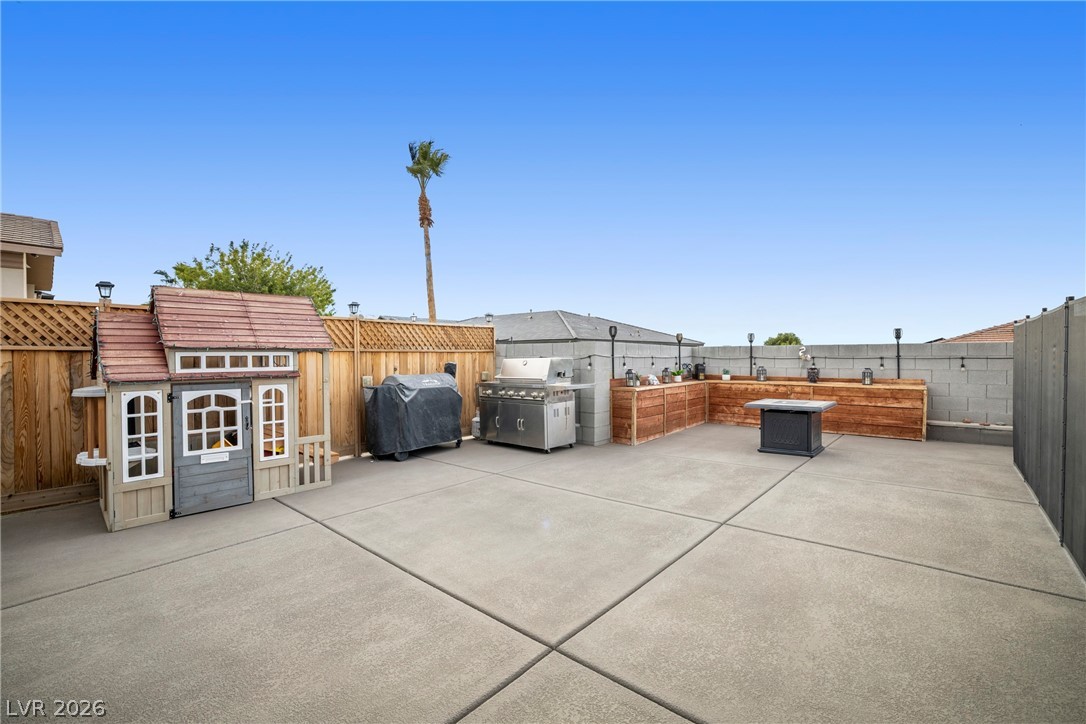 432 North Racetrack Road Henderson, NV 89015 - Photo 35 of 45 Fenced backyard with a grill and a patio area