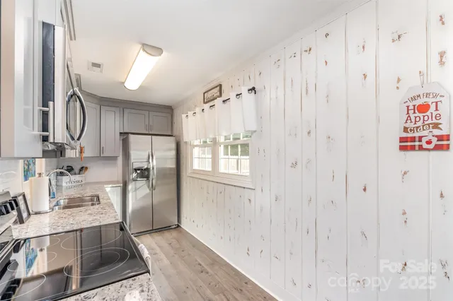 a view of kitchen with furniture and wooden floor
