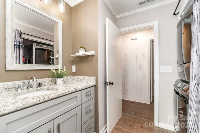 a en suite bathroom with a granite countertop sink and a mirror