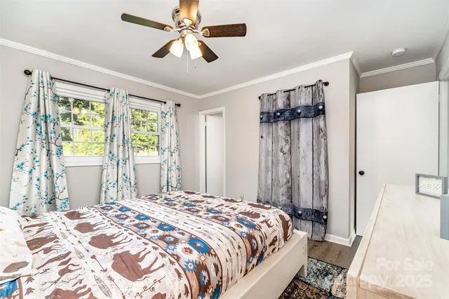 a bedroom with a large bed and a window