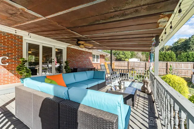 a view of a patio with couches chairs with wooden floor
