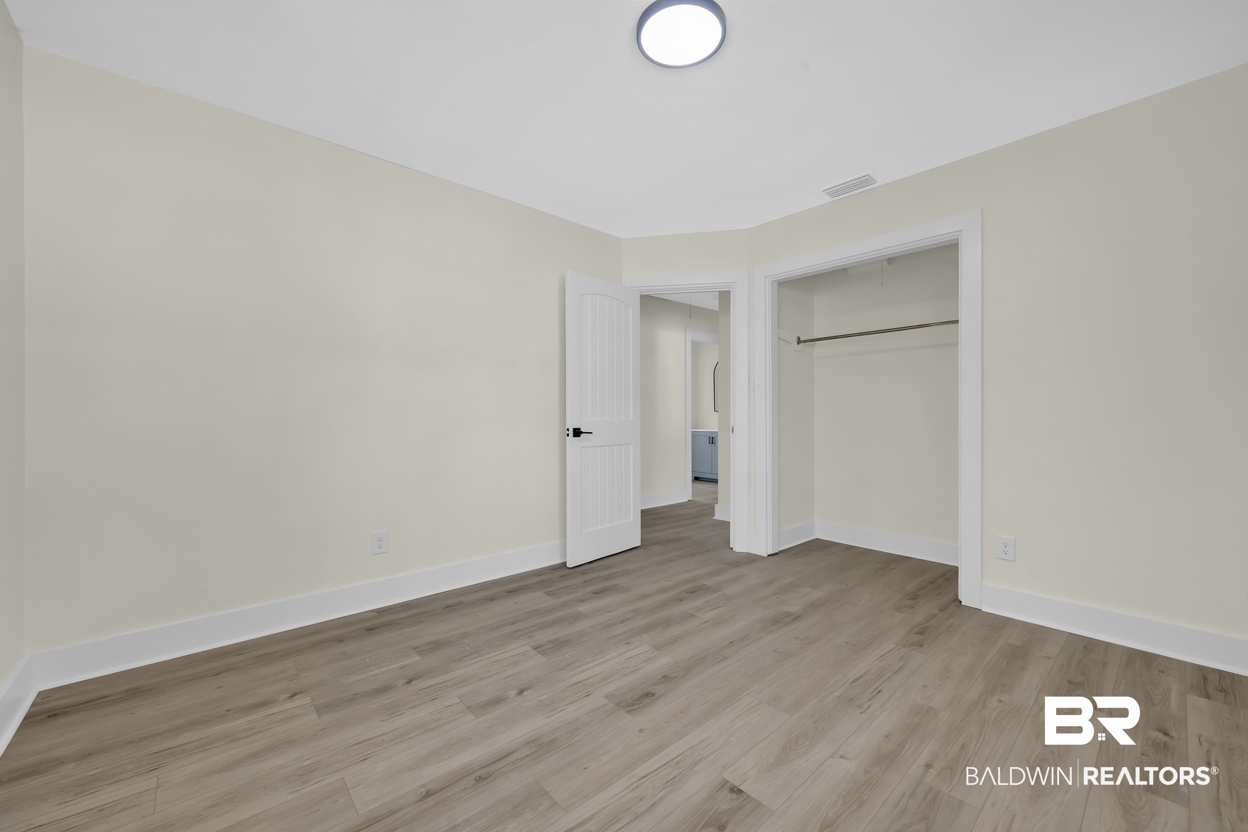 1409 Altair Lane Mobile, AL 36693 - Photo 14 of 23 Unfurnished bedroom with light wood-style flooring and a closet