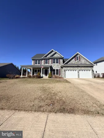 a view of a big house with a big yard and large trees