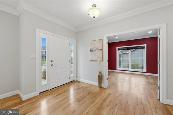 a large kitchen with granite countertop a large counter top a sink stainless steel appliances and cabinets