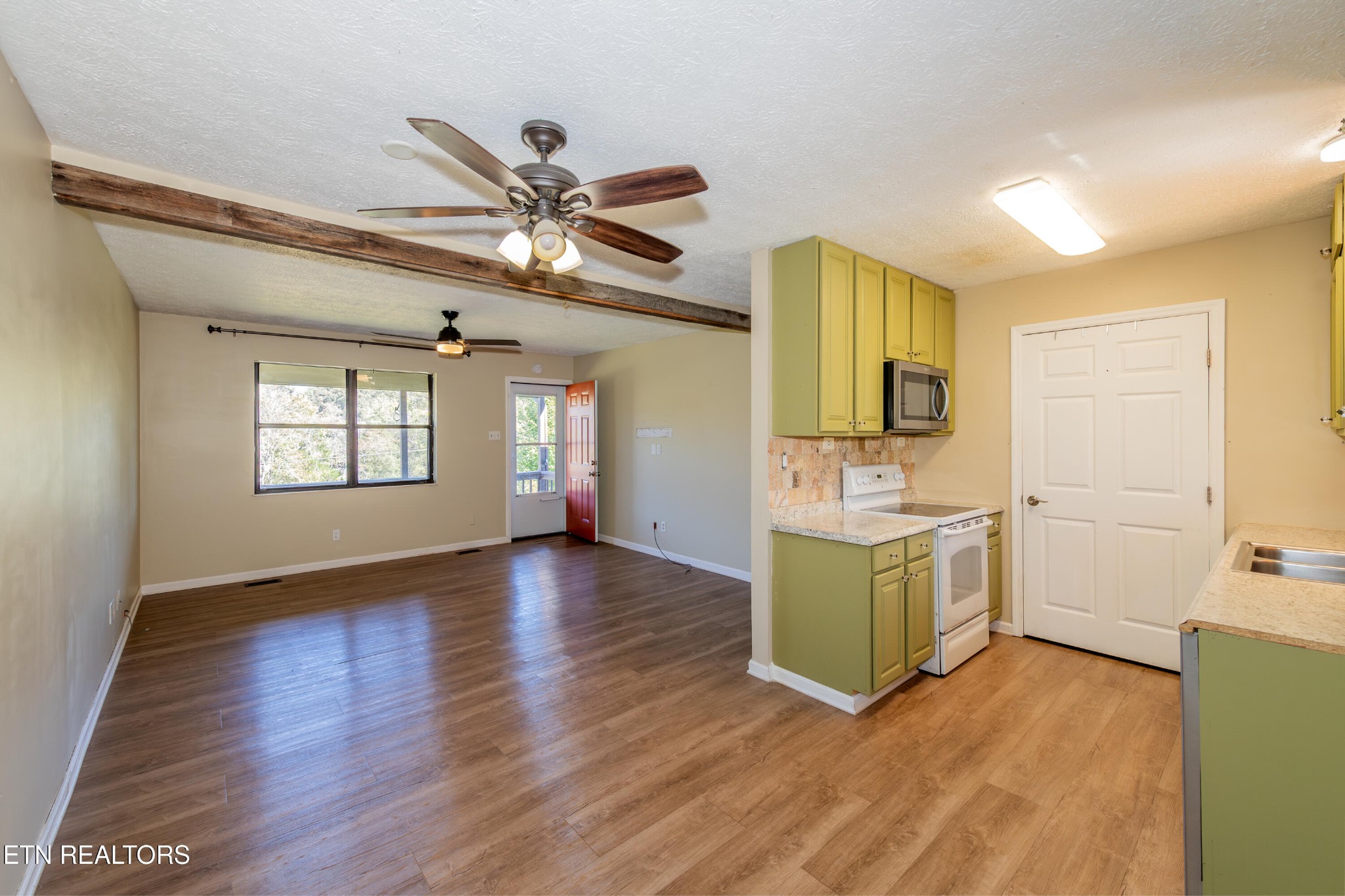 759 Laurel Road Clinton, TN 37716 - Photo 13 of 28 a view of a kitchen with a sink dishwasher a refrigerator with wooden floor