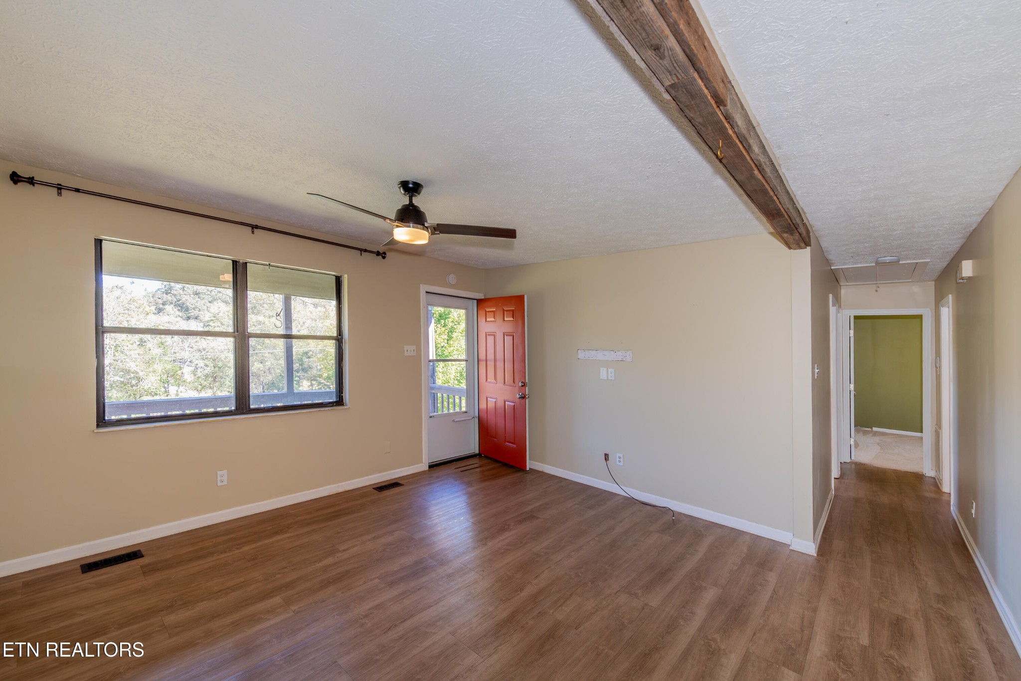 759 Laurel Road Clinton, TN 37716 - Photo 9 of 28 a view of an empty room with wooden floor and a window