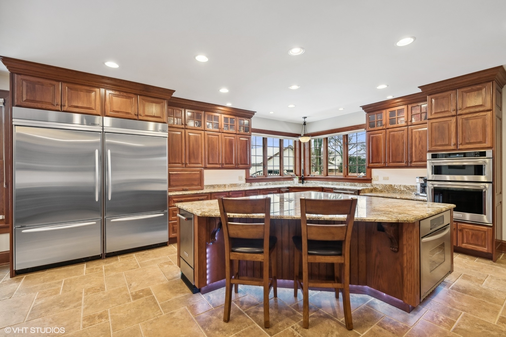 381 Argyle Avenue Elmhurst, IL 60126 - Photo 14 of 63 a kitchen with stainless steel appliances granite countertop a stove and a refrigerator
