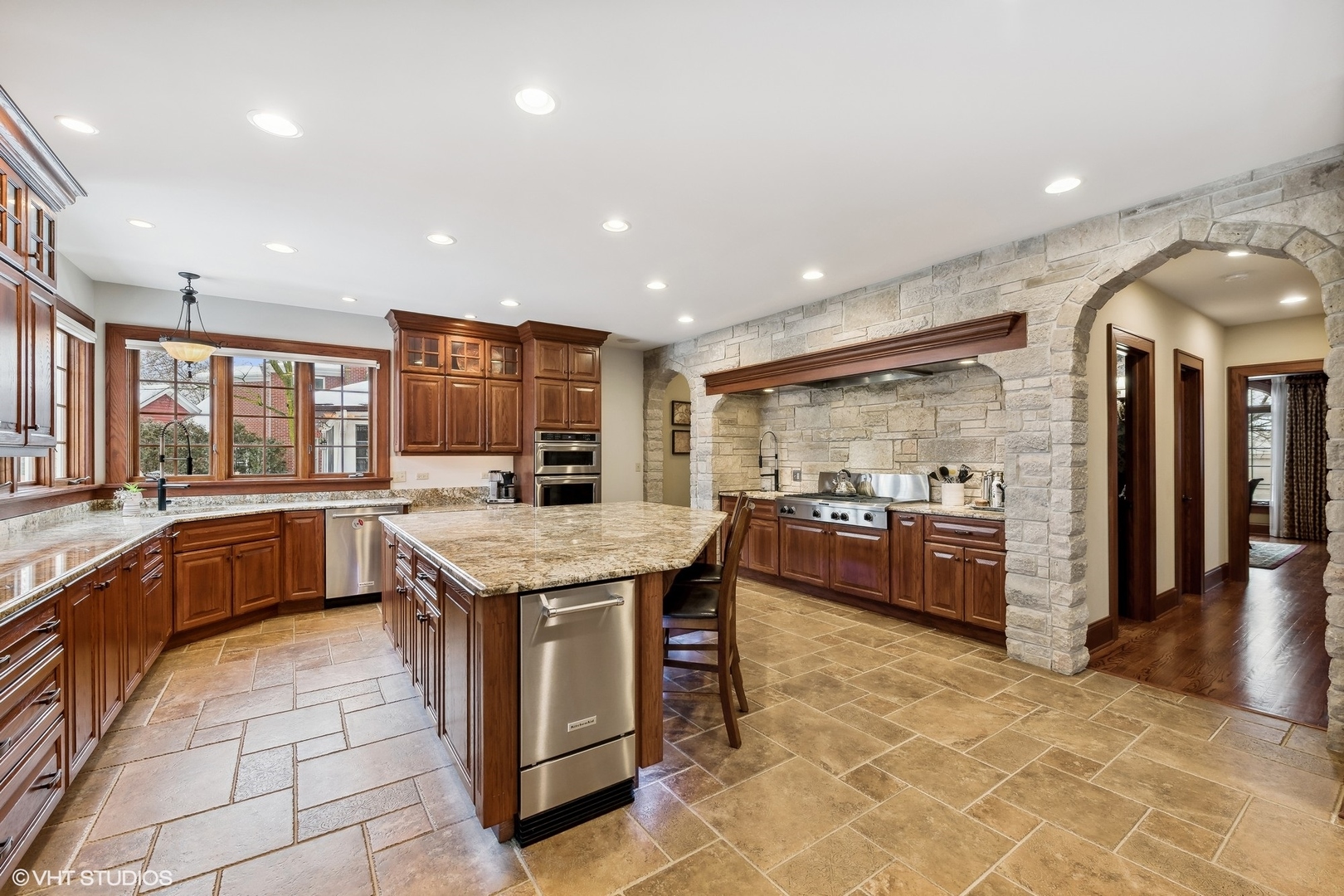 381 Argyle Avenue Elmhurst, IL 60126 - Photo 16 of 63 a kitchen with stainless steel appliances granite countertop a stove a sink and a refrigerator