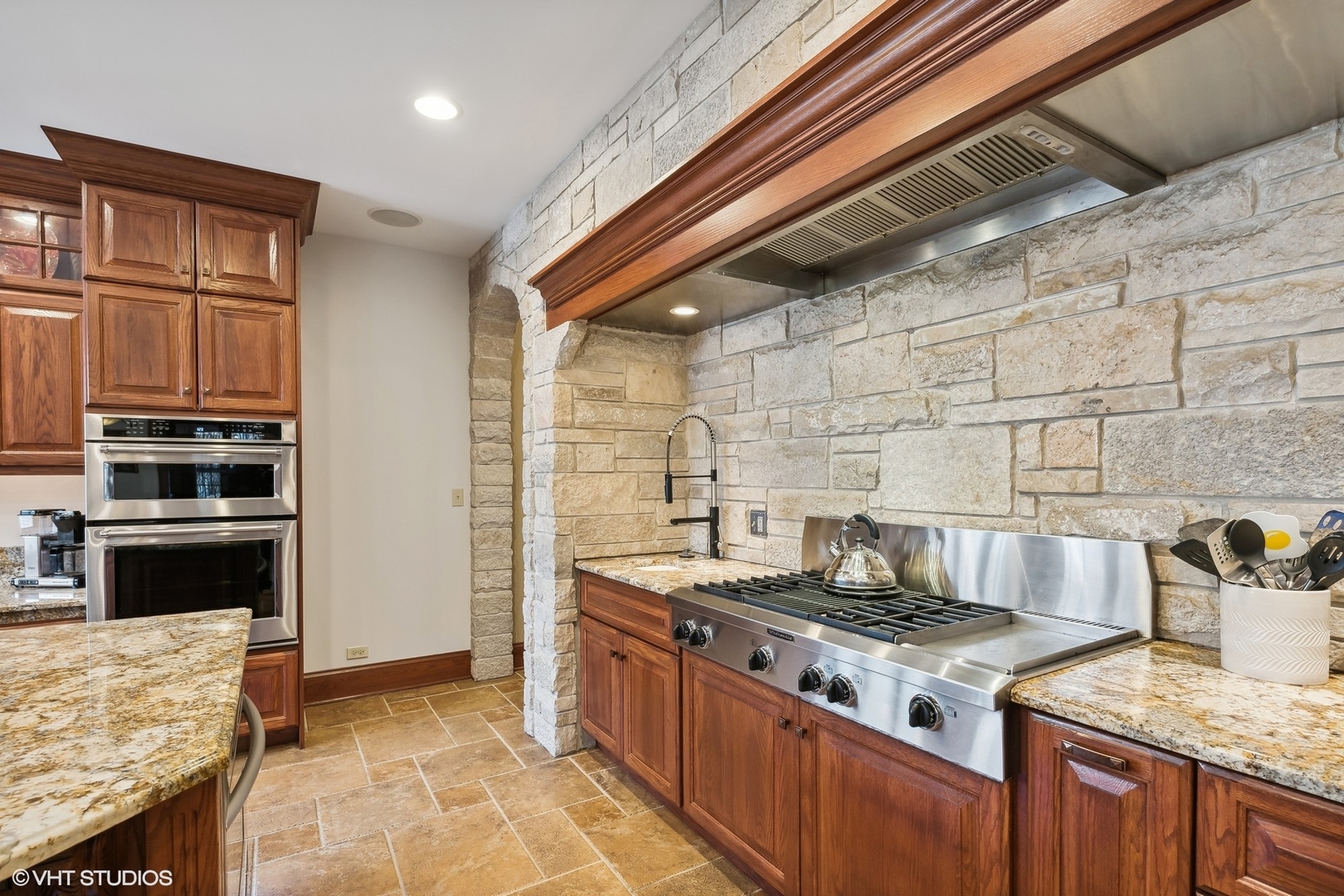 381 Argyle Avenue Elmhurst, IL 60126 - Photo 17 of 63 a kitchen with stainless steel appliances granite countertop a stove and a sink