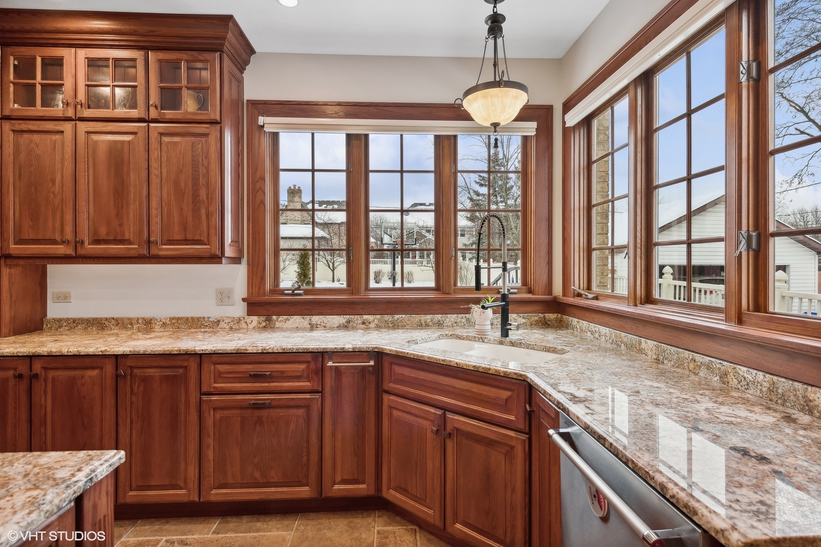 381 Argyle Avenue Elmhurst, IL 60126 - Photo 18 of 63 a kitchen with stainless steel appliances granite countertop wooden cabinets a sink and a window