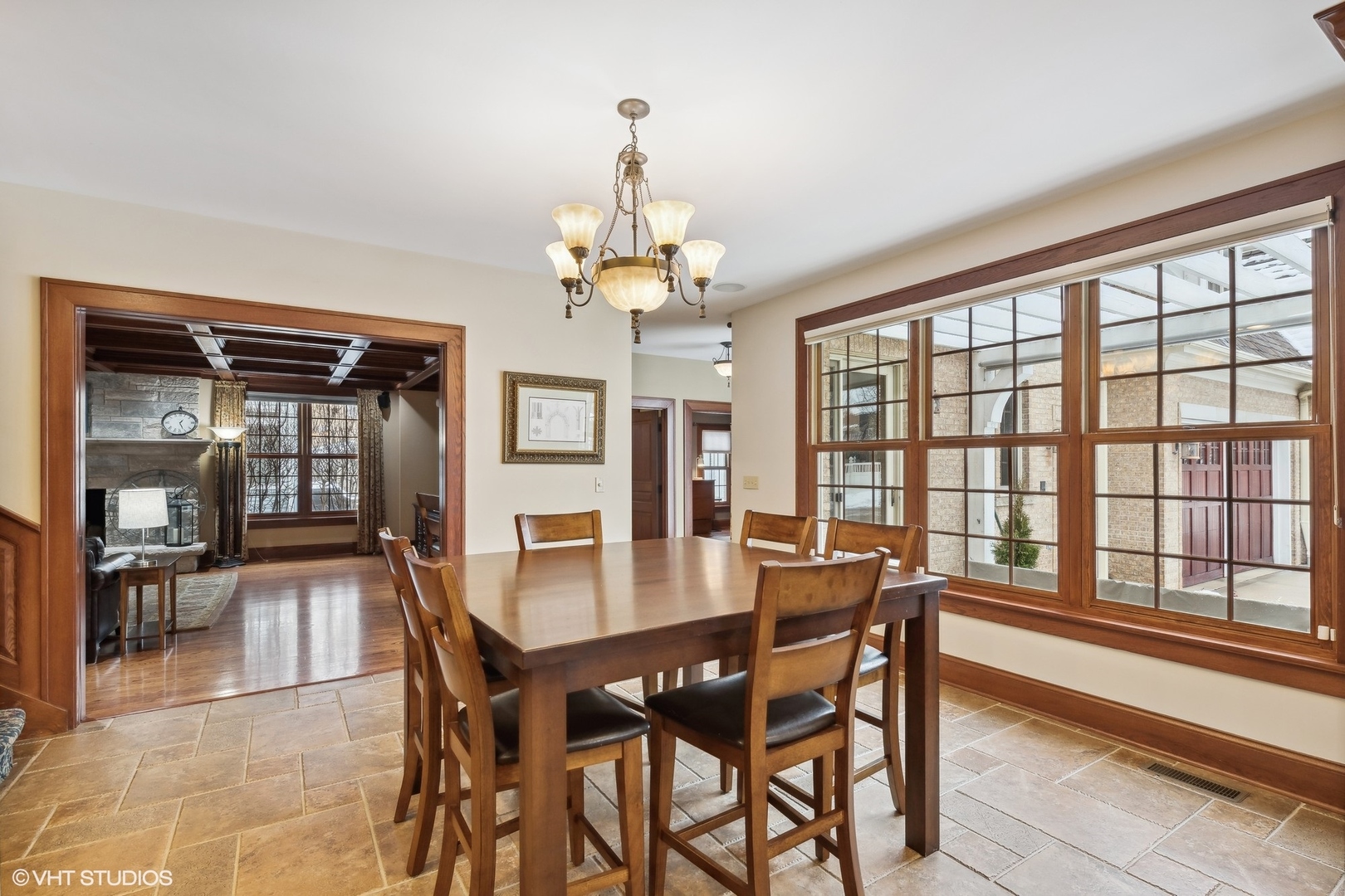 381 Argyle Avenue Elmhurst, IL 60126 - Photo 20 of 63 a dining room with wooden floor a chandelier a wooden table and chairs